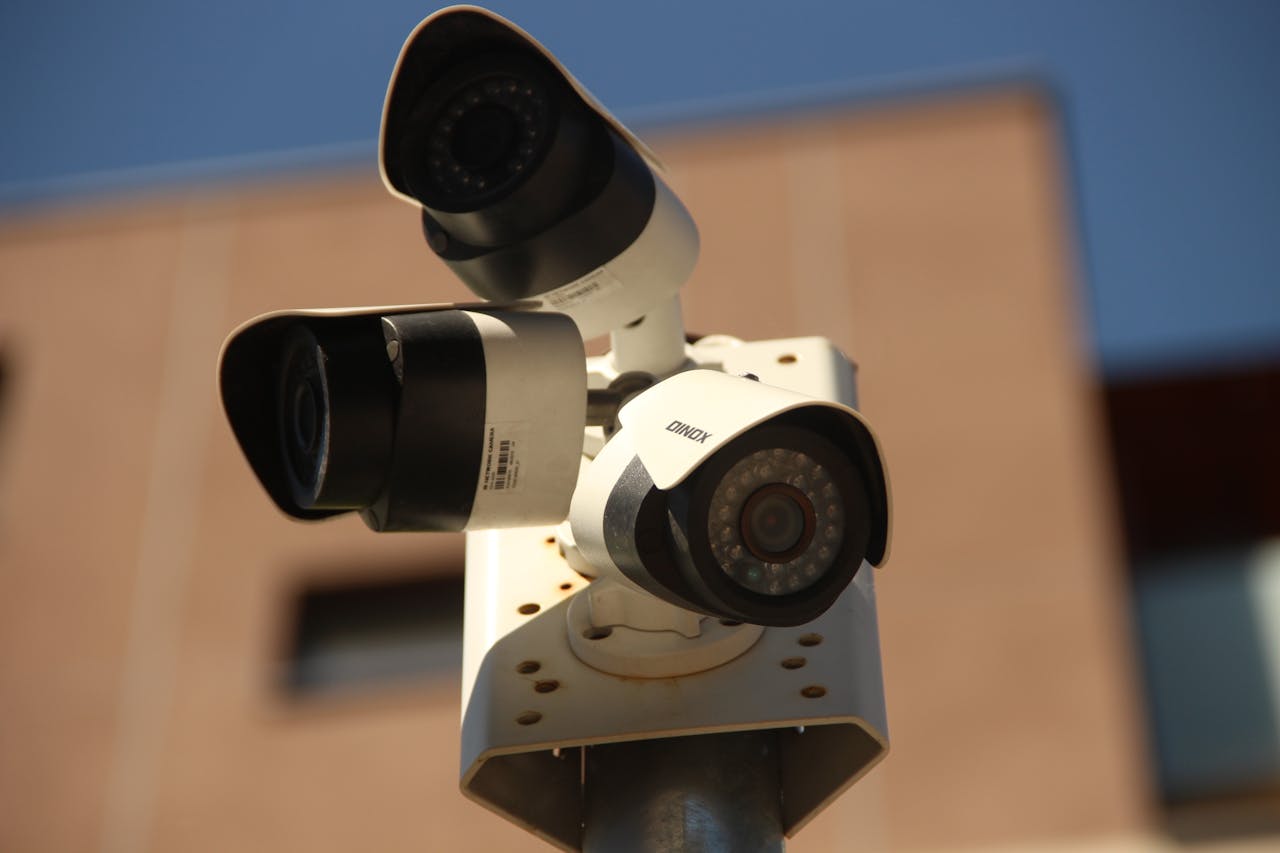 services-01 High-resolution surveillance cameras installed in a city environment for security purposes.