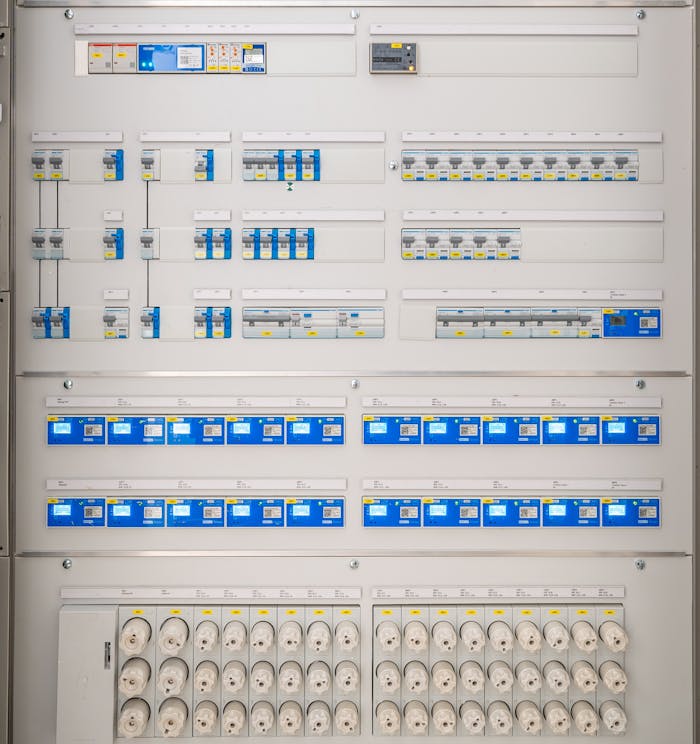journey Detailed view of a modern electrical panel featuring circuit breakers and sockets for efficient energy distribution.